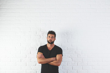 Wall Mural - Thoughtful man with folded arms