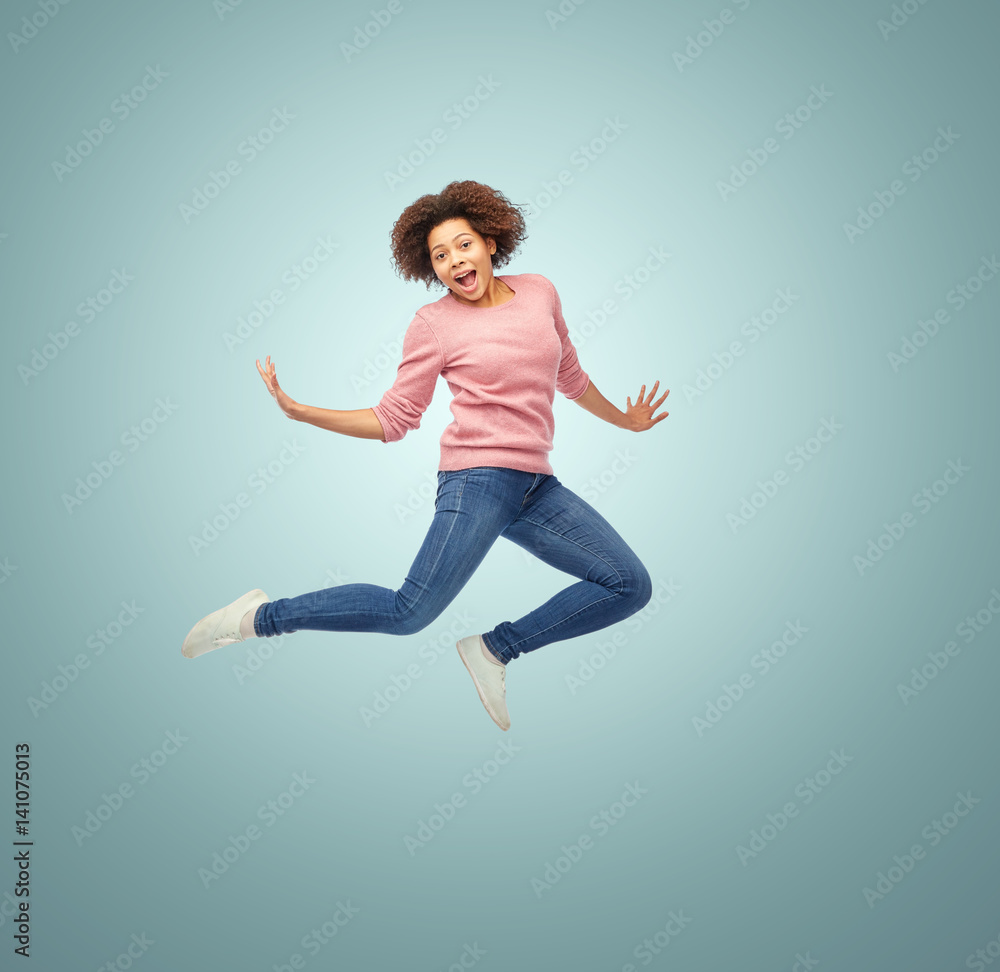 Stock-Foto „happy african american woman jumping over white“ | Adobe Stock
