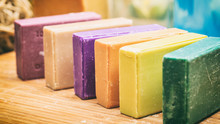 Variety Of Soap Bars On Wooden Background