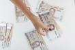 © Vladimir Borozenets - Woman give or hold Thousand banknote of Thailand