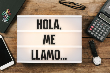 Wall Mural - Hola, me llamo…, Spanish text for Hello, My Name is... in vintage style light box on office deskt op