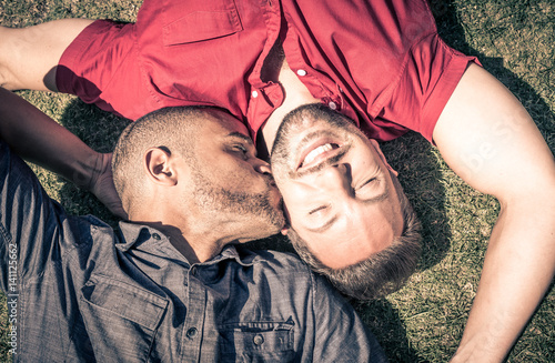 Happy gay couple lying down on the grass Tapéta, Fotótapéta