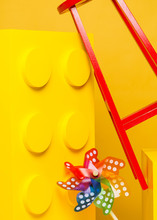 Red Stool And Yellow Blocks On Yellow Background. Toys For Kid Photography.