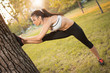 © Bojan - Young sportive woman doing stretching exercises in the park.