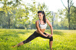 © Bojan - Beautiful young woman doing stretching exercises in the park.