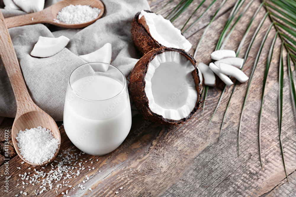 Composition with tasty coconut milk on wooden background