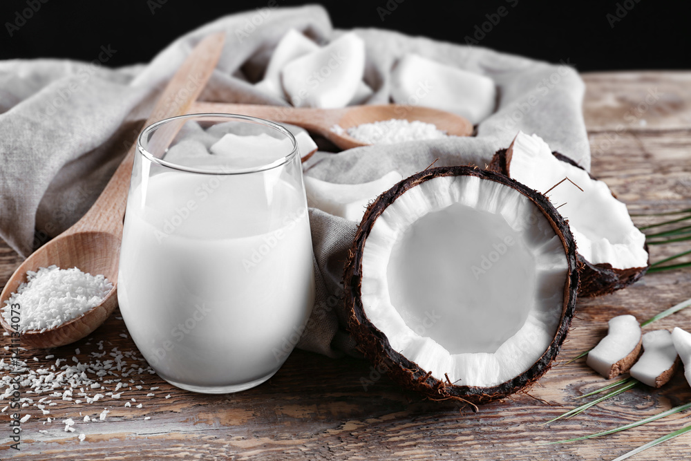 Composition with tasty coconut milk on wooden background