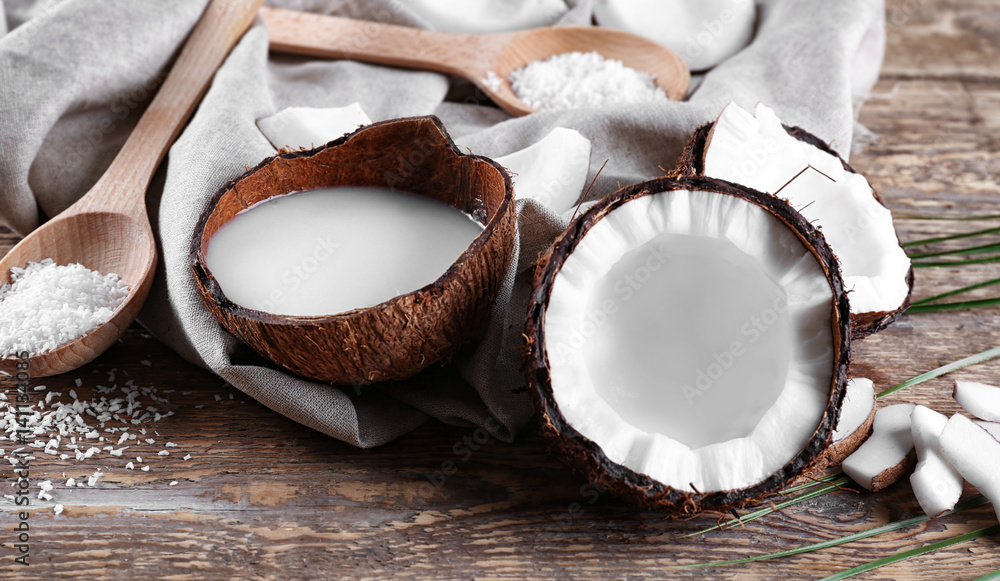 Composition with fresh coconut milk on wooden background
