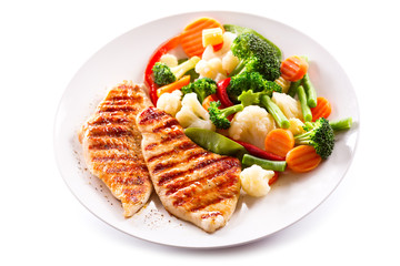 Canvas Print - plate of grilled chicken with vegetables on white background