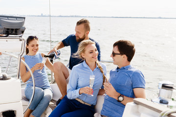 Group of happy friends having a party on a yacht and drinking champagne.  Vacation, holiday, traveling, concept.