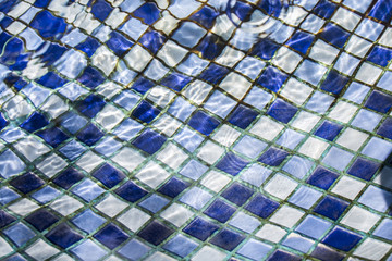 Blue tile pattern in the pool with clear water