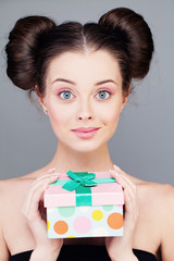 Wall Mural - Young Woman with Gift Box. Smiling Fashion Model