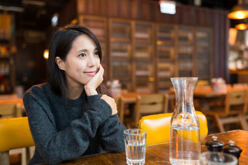 Wall Mural - Woman thinking something in restaurant