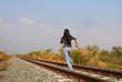 Woman running on railway, run away, need to escape, going far, towards the unknown, best way to relax, to decompress and to kill stress 
