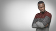 Studio portrait of skeptical African American young male in casual sweater looking with suspicious or annoyed expression, with hands folded on chest. Copy space for your text or advertising content