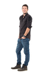 Wall Mural - Relaxed happy laughing young man wearing jeans and plaid shirt. Full body length portrait isolated over white studio background. 