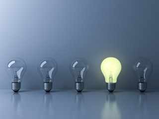 Aufkleber - One glowing light bulb standing out from the unlit incandescent bulbs on blue background with reflection and shadow , individuality and different creative idea concepts . 3D rendering.