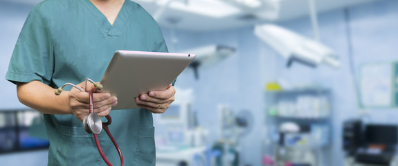 Male doctor,medical students or surgeon using digital tablet and laptop during the conference,Health Check with digital system support for patient,test results and patient registration,selective focus