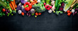 canvas print picture - Big set organic food. Fresh raw vegetables. On a black chalkboard.