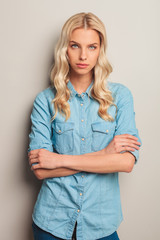 Poster - casual blonde woman standing with hands crossed