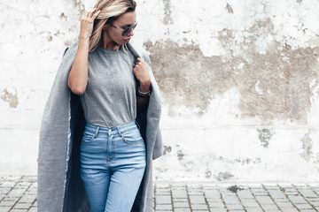 Model posing in plain tshirt against street wall