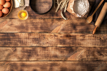Poster - Baking ingredients on a wooden table with copy space