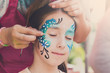 © Prostock-studio - Female child face painting, making butterfly process