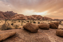 Round Stones In The Namibian Savanna At Sunset
