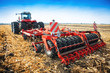 Modern tractor in the field with complex for the plowing of soil.