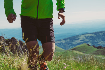 Wall Mural - man trail running on a mountain in summer