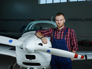 Wall Mural - Young inventor of new model of jetliner looking at camera