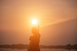 © Chittakon - Woman hands sunsets