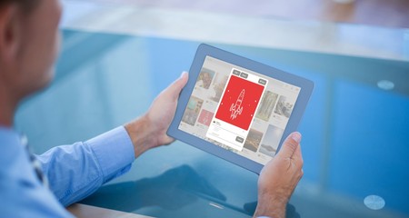 Wall Mural - composite image of businessman using his tablet