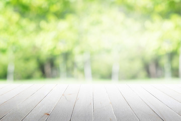 Wall Mural - Empty wooden table with party in garden background blurred.