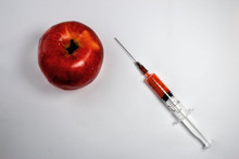 Red Apple With A Hypodermic Needle Syringe