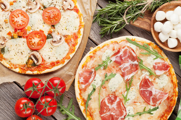 Pizza with prosciutto, tomatoes and mushrooms