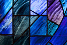 Beautiful Shades Of Deep Blue And Purple On Uniquely Shaped Stained Glass Window.
