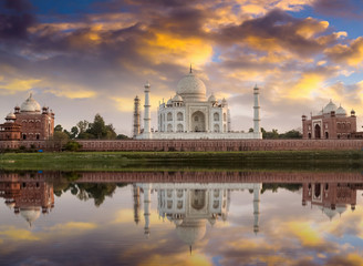 Fototapete - Taj Mahal at sunset as seen from the Yamuna river banks with moody sky. Taj Mahal designated as a World Heritage Site is a masterpiece of Indian heritage and architecture.