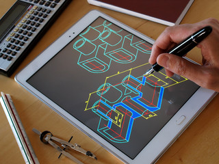 Wall Mural - designer working on a cad blueprint using tablet computer