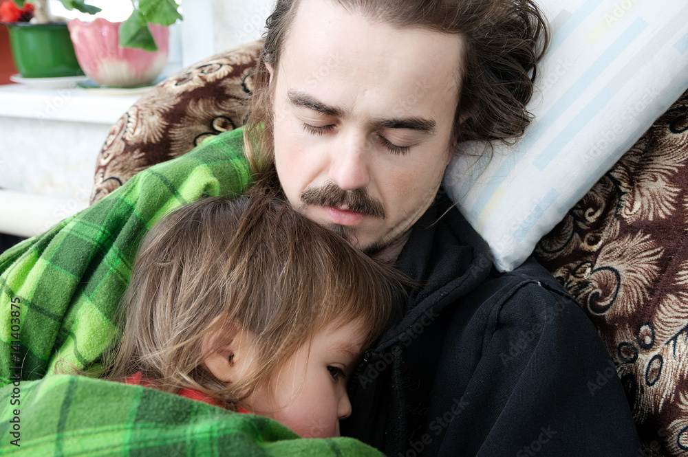 Father and kid sleeping together home on armchair. Family resting ...