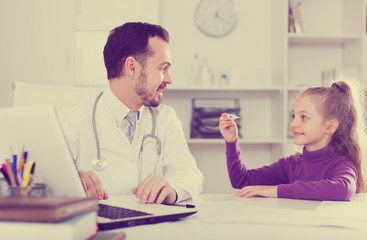 Male doctor and little girl