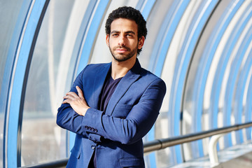 Wall Mural - Portrait of Arab man in a suit in the glass transition