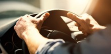Cropped Hands Of Man Holding Steering Wheel