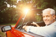 Smiling Man Driving Red Car