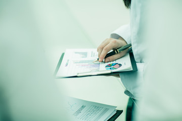 businessman working with financial charts.photo on a light backg