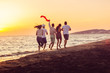 © FS-Stock - Group of happy young people is running on background of sunset beach and sea