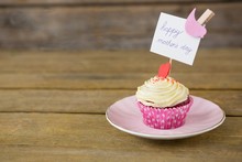 Close-up Of Delicious Cupcake With Happy Mothers Day Label