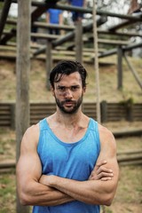 Wall Mural - Portrait of determined man standing with arms 