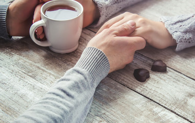 lovers holding together a Cup of tea. Selective focus.  