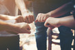 © Johnstocker - Close up of young people putting their hands together. Team with stack of hands showing unity and teamwork.